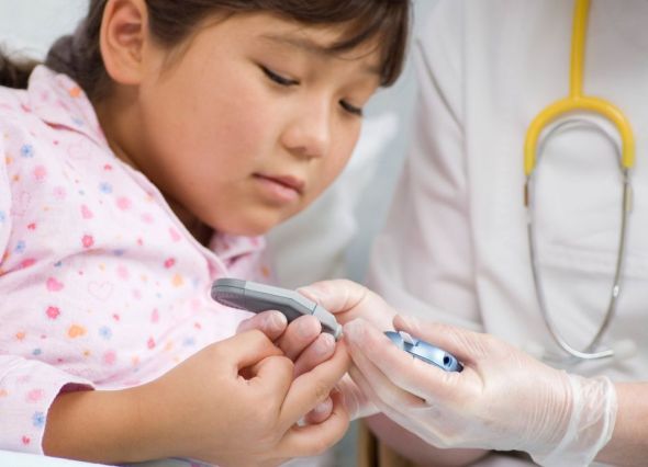 Little girl and Doctor checking blood sugar levels