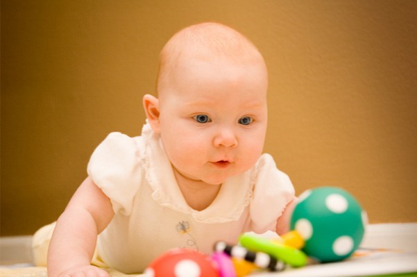 Baby crawling and playing with toys