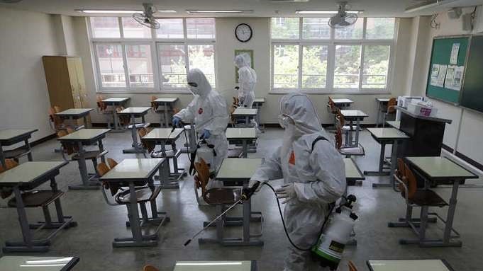 School being cleaned in preparation for students return. This is security theater, it spreads from student to student more readily than from desk to student.