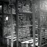 Black and white photo of the Cincinnati Old Main Library taken 1874. There is a single person for scale and the library is massive in size with several levels seen in the single photo alone. Unfortunately the library was torn down in 1955.