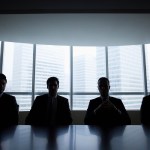 Silhouette row of businessmen sitting in meeting room